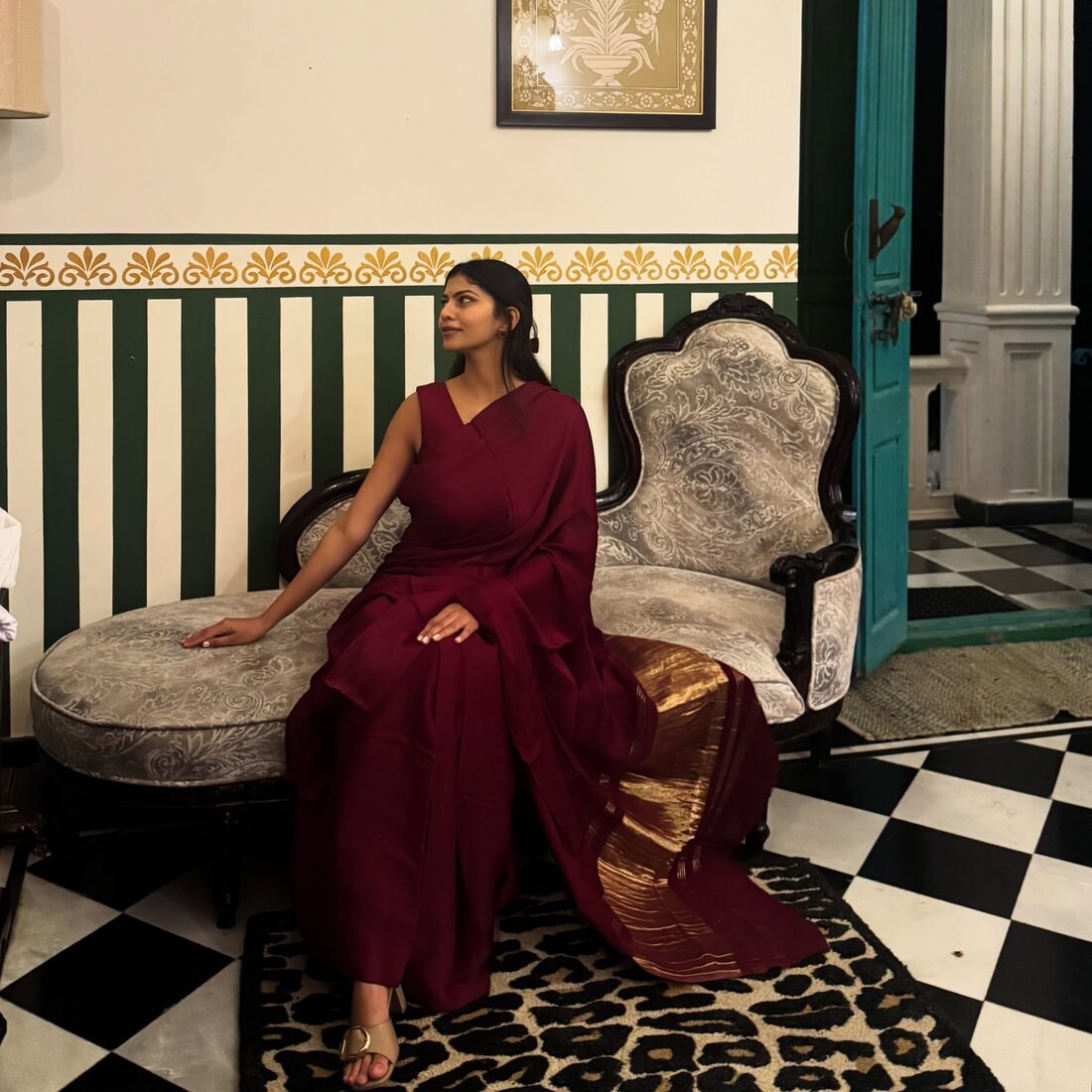 Shreya Jadhav in a maroon saree in a heritage interior