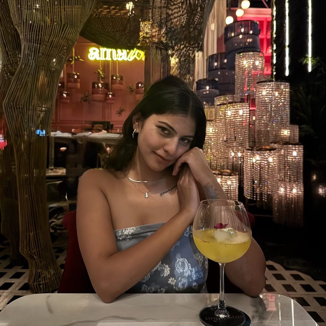 Shreya Jadhav at a softly lit restaurant table